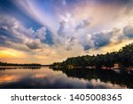 COTTAGE LAKE IN CANADA - Beautiful sunrise/sunset clouds over a lake at a cottage. Quiet, peaceful, serene scene with boats in water and houses on lakefront. Gorgeous clouds in sky. Muskoka, Canada