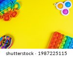 Small photo of Anti-stress toys pop it, simple dimple, snapperz on yellow background, copy space. Concept trendy entertainment for fidget children, sensory toys, development of fine motor skills, stress relieving.