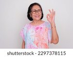 Small photo of Elderly Asian woman smiling and give OK hand sign