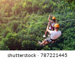 Zipline is an exciting adventure activity. Man and woman hanging on a rope-way. Tourists ride on the Zipline through the canyon of the Tara River Montenegro. Couple in helmets is riding on a cable car