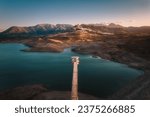 Small photo of Aerial view of Zahara de la Sierra, with lake and tower in foreground at dusk, Cadiz, Spain
