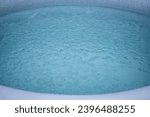 Small photo of Portable plastic inflatable tub in a garden ready for ice bathing in the cold water filled with ice cubes. Wim Hof Method, cold therapy, breathing techniques, yoga and meditation