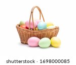 Multi colors Easter eggs in the woven basket isolated on white background with clipping path. Pastel color Easter eggs.