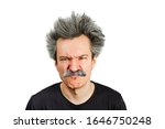 Small photo of Portrait of jocular aging man with grey long hair wrinkles his nose from sour on his face in Einstein manner. Isolated on background.