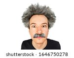 Small photo of Portrait of jocular aging guy with grey long hair sticking his tongue out in Einstein manner. Isolated on background.