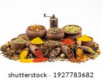 Assortment of east spices and seasonings in wooden tableware by close up isolated on a white background.