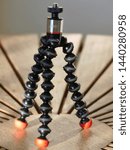 Small photo of Chorleywood, Hertfordshire, England, UK - July 2nd 2019: Joby GorillaPod Magnetic 325 a compact, flexible tripod with magnetic feet placed on wooden table