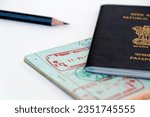 Small photo of Dubai, United Arab Emirates - August 2, 2023 UAE visa stamping procedure, united arab emirates and indian official stamps on a passport page, letters mentioned in arabic and hindi language also