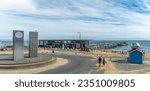 Small photo of Boscombe, UK - August 11th 2023: The sculpture From Dawn until Dusk by Simon Hitchens and the mirrorball on a hut in front of the entrance to Boscombe Pier.