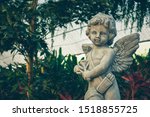Cupid Sculpture In The Garden ...