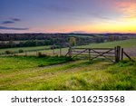 Sunset Over Field Gate In The...