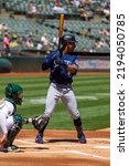 Small photo of Oakland, California - August 21, 2022: Seattle Mariners outfield Julio Rodriguez bats against the Oakland Athletics at the Oakland Coliseum.