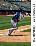 Small photo of Oakland, California - August 21, 2022: Seattle Mariners outfield Mitch Haniger hits a home run against the Oakland Athletics at the Oakland Coliseum.