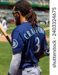 Small photo of Oakland, California - August 21, 2022: Seattle Mariners shortstop J.P. Crawford in the on deck circle during a game against against the Oakland Athletics at the Oakland Coliseum.