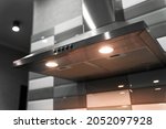  kitchen metal hood with illumination close-up. extractor hood in the restaurant. electrical equipment for the kitchen                           