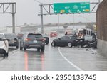 Small photo of Los Angeles, California, USA - August 20,2023: Heavy rains and a three car accident on the 5 freeway just before the 118 freeway interchange during heavy rains of tropical storm Hurricane Hilary.