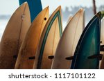 Small photo of Set of different color surf boards in a stack by ocean.WELIGAMA, SRI LANKA. Surf boards on sandy Weligama beach in Sri Lanka. surf is available all year around for beginner and advanced