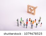 Small photo of human figures stand together next to a tick in the box. The concept of elections and social technologies. Volunteers, parties, candidates, constituency electorates. Human rights Selective focus