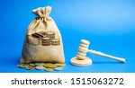 Small photo of Money bag and judge's hammer. Penalty for a crime and offense. Financial punishment. Violations of traffic laws. Fraud. Fine, penalization, mulct. Gavel