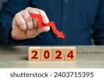 Small photo of 2024 and red arrow down. Forecast for an decrease next year. Fall in profits and orders, economic decline. Unfavorable investment conditions. Stagnation and recession. A crisis. Pessimistic forecast.