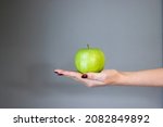 green apple standing in woman's ... | Shutterstock . vector #2082849892