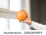 orange standing in woman's hand ... | Shutterstock . vector #2082849895