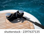 Small photo of Detail shot of a mooring line tied off on a cleat on the stern area of a modern superyacht docked in marina