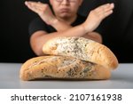 Small photo of Man eating moldy dirty bread. man standing holding moldy bread. Moldy bread on blurry background. food fungus. Dirty food that is unappetizing.