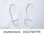 two rough boot prints on the fresh snow, background