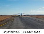 White passanger plane on runway air strip while takeing off take off in iceland keflavik northern country clear blue sky