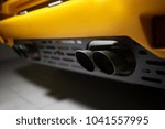 Exhaust pipes of a classic yellow retro supercar