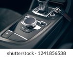 Media and navigation control buttons of modern supercar. Carbon control panel