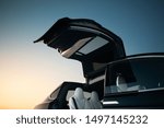 Modern and futuristic SUV car vertical door. Expensive and luxury crossover with falcon wings style door 