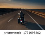 Small photo of An Awe-Inspiring Shot of a Solo Motorcycle Rider Speeding along an Open, Vast Asphalt Motorway, Emphasizing the Thrill and Freedom of the Open Road on a Long, Straight Driveway