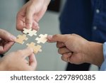 Small photo of The concept of teamwork and partnership Hands joining puzzle pieces in office Businessmen put together a jigsaw puzzle - volunteer charity team business uniy.