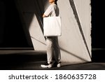 Girl holding white tote bag, template can be used for your design