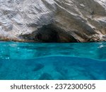 Small photo of Mavi Magara - blue cave near Oludeniz, split underwater image