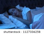 Young Woman Sleeping In Bed At...