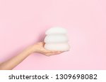 Woman holding silicone implants for breast augmentation on color background, space for text. Cosmetic surgery