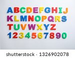 Plastic magnetic letters and numbers isolated on white, top view