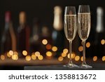 Glasses of champagne on table against blurred background. Space for text