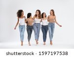 Group of women with different body types on light background