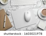 Modern workplace with mouse and keyboard on marble table, flat lay