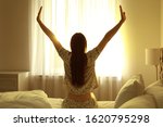 Young Woman Stretching On Bed...