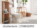 Interior of stylish bathroom with toilet bowl and decor elements