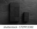 Small photo of Flat lay composition with cubes on black slate background. Pareto principle concept