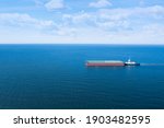 Tugboat Pulling Barge With...