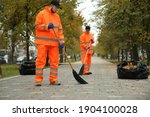 Street cleaners sweeping fallen ...