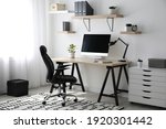 Comfortable office chair near table with modern computer