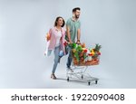 Young couple with shopping cart ...